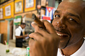 Havana, Cuba - Cuban Man with his cigar in a close up, low depth of field portrait in a bar in old Havana