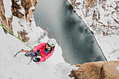 High angle view of woman ice climbing at Chipeta falls, Colorado