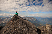 Female Climber Sitting On Top Of Mount Marriott