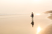A Male Surfer Walking On The Beach In Nicaragua