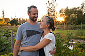 Portrait Of A Couple Standing In Their Garden In Fort Langley