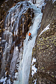 Man Ice Climbing In Simplonpass, Switzerland