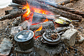 High Angle View Of Food Being Prepared In Cast Iron Cooking Vessels
