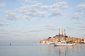 View across harbour to old town of Rovinj at sunset