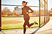 A Woman With Her Headphones Running On Ground In Boston, Usa