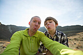 A Dad And His Son Have Fun With A Selfie While On A Hike