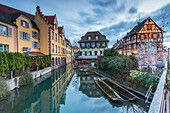 Dusk lights on houses reflected in river Lauch at Christmas Petite Venise Colmar Haut-Rhin department Alsace France Europe