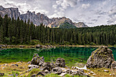 Karersee lake and the Latemar mountain group in a cloudy day, Dolomites