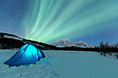 Camping with tent during a night with the Northern Lights, Svensby, Ullsfjorden, Lyngen Alps, Troms, Norway, Lapland, Europe