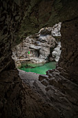 Dolomites, Belluno, Veneto, Italy, Man exploring the gorge of the Soffia waterfall, Mis valley