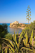 Sunrise on turquoise sea frames the medieval Falconara Castle Butera province of Caltanissetta Sicily Italy Europe