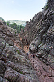 Hikers proceed in the rocky canyon Col de Bavella , Pass of Bavella, Solenzara Southern Corsica France Europe