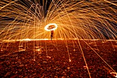 man who practices the technique of steelwool, piacenza, emilia romagna, italy