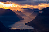 Sunset closing in on the mountains and the beautiful Glacial Lake Lugano, Switzerland