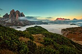 The Cadini of Misurina (Misurina's Cadini) and in the distance the Zwölferkofel (Croda dei Toni) illuminated by sunset, while in the valley is forming a dense fog Autumnal panorama seen from Croda of Ciampoduro, near the CittÃ  of Carpi Hut, Dolomites, Ca