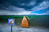 No swimming sign and wooden jetty, Lohals Harbour, Tranekær, Baltic Sea, Langeland, Denmark