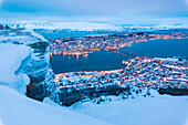 View of the city of Tromso at dusk from the mountain top reached by the Fjellheisen cable car, Troms, Northern Norway, Scandinavia, Europe