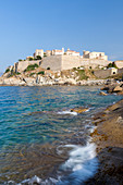 The old fortified citadel on the promontory surrounded by the clear sea, Calvi, Balagne Region, northwest Corsica, France, Mediterranean, Europe