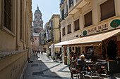 Malaga Cathedral and cafe in narrow street, Malaga, Costa del Sol, Andalusia, Spain, Europe