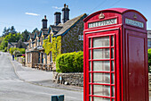 Red telephone box in Beeley Village in springtime, Derbyshire Dales, Derbyshire, England, United Kingdom, Europe