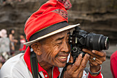 'Official photographer for tourists in Tanah Lot temple; Bali Island, Indonesia'
