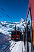 'Gornergrat cog railway climbing to the Gornergrat Kulm hotel and observatory at 3100m, boasting an amazing view of the Matterhorn and the Pennine Alps surrounding Zermatt; Switzerland'