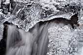 'A small waterfall and ice in early March, Horse Pasture Brook, a protected wilderness area; Wentworth Valley, Nova Scotia, Canada'