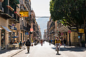 Pedestrians and cyclist on Via Maqueda road, Palermo, Sicily, Italy, Europe