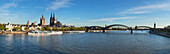 Panoramic view over the Rhine river to the Old town with town ha, Gross-St-Martin church, cathedral and Hohenzollern bridge, Cologne, North Rhine-Westphalia, Germany