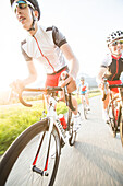 Three young people on their racing cycles, Kitzbühlerhorn, Tyrol, Austria