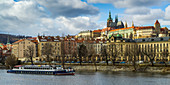'A boat on the Vltava River with a view of the city of Prague; Prague, Czech Republic'