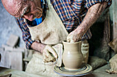 'One of the best potters at Telavi shows his craftsmanship; Telavi, Kakheti, Georgia'