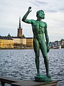 Statue of a naked man on the waterfront at City Hall, Stockholm, Sweden