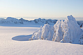 Rugged Kenai mountain peaks covered in snow against a blue sky, Kachemak Bay State Park, Alaska, United States of America