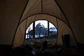 View from inside a tent through the door to the rugged peaks of the Kenai Mountains, Kachemak Bay State Park, Alaska, United States of America