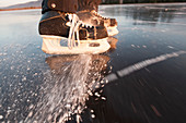 Eishockey-Skates Spritzen Eis auf einer gefrorenen Oberfläche, Alaska, Vereinigte Staaten von Amerika