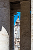 Die Kuppel des Petersdom Basilica di San Pietro durch die Säulen am Petersplatz gesehen, Rom, Latium, Italien