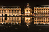 Place de la Bourse is reflected in the Miroir d'eau fountain at night