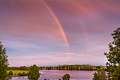 Rainbow over river Eider, Suederstapel, Stapelholm, Schleswig-Holstein, Germany