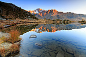 Rocky peaks of Mount Disgrazia reflected in Lake Zana at sunrise, Malenco Valley, Valtellina, Lombardy, Italy, Europe