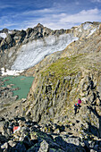 Two persons ascending Aperer Turm, glacier Turmferner and glacier lake in background, from Aperer Turm, Stubai Alps, Tyrol, Austria
