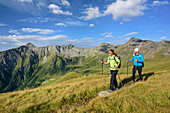 Woman and man hiking, Boeseck in background, Tauern ridgeway, High Tauern range, Salzburg, Austria