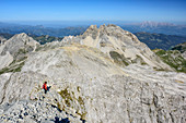 Woman hiking descending from Grosses Mosermandl, Faulkogel in background, Grosses Mosermandl, valley Riedingtal, Radstadt Tauern, Lower Tauern, Carinthia, Austria