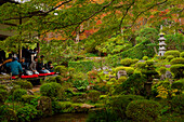 Tourists enjoying early autumn colours in Sanzen-in Temple, Kyoto, Japan, Asia