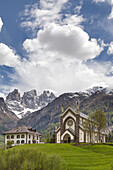 Europe, Italy, Veneto, Falcade, The parish church and the peaks of the Focobon, Biois valley, Dolomites