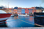 Colourful facades and typical boats along the canal and entertainment district of Nyhavn, Copenhagen, Denmark, Europe