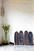 Row of skateboards against wall