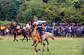 Men riding horses and throwing spear at Pasola Festival, Sumba island, Indonesia