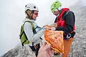 A Group Of Friends Having A Slice Of Pizza At The Summit Of Punta Anna