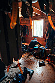 A man working on his skis after a long day in the backcountry, Icefall Lodge. B.C.